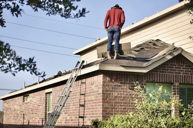 Professional roofer working on a residential roof in Conneaut